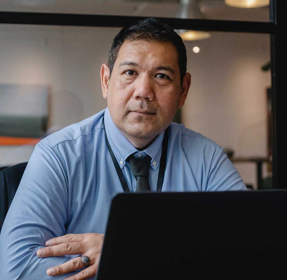 Man Working behind Laptop professional tax preparer